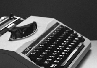 white and black typewriter close-up photography