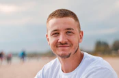 man wearing white crew-neck shirt outdoor selective focus photography