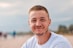 man wearing white crew-neck shirt outdoor selective focus photography