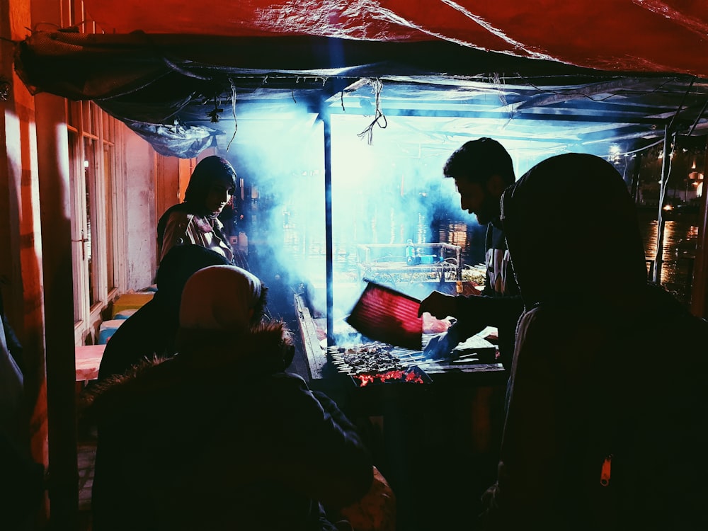 a group of people standing around a fire