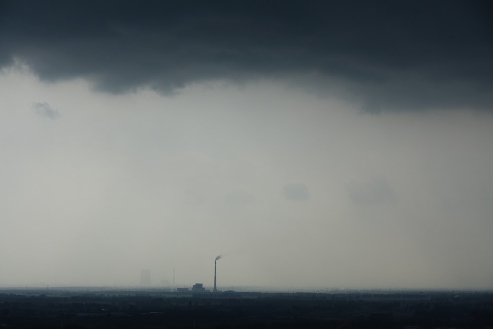 a very dark sky with some clouds in the background