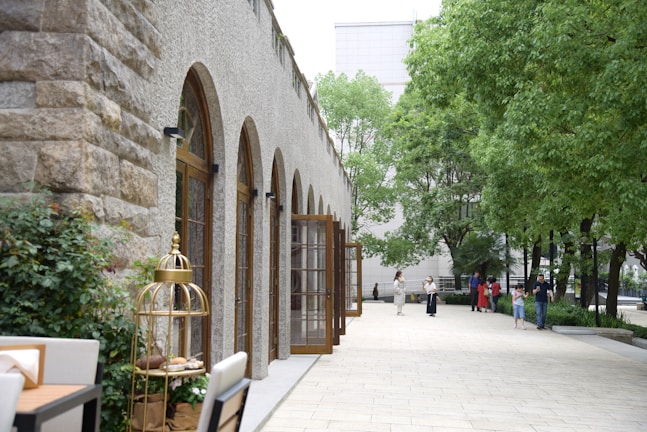 A spacious outdoor area featuring a combination of walkways, green spaces, and decorative masonry.