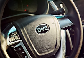 black vehicle steering wheel close-up photography