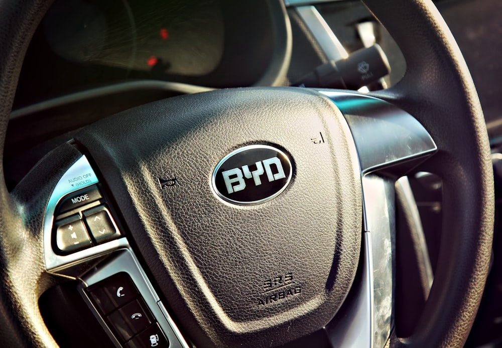 black vehicle steering wheel close-up photography