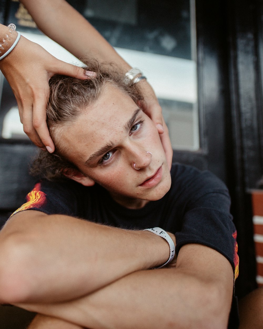 person massaging man in black t-shirt