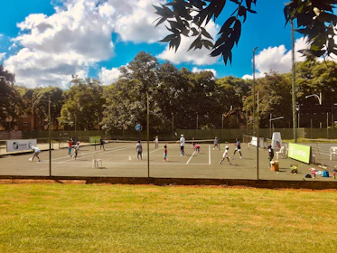 Group of tennis players competing in a friendly match during training.
