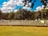 A group of diverse people playing tennis on a bright day.