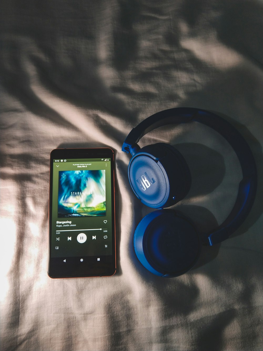 phone near a blue headphone close-up photography