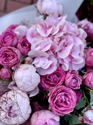 A vibrant bouquet of roses, lilies, and peonies arranged elegantly for a grand wedding celebration.