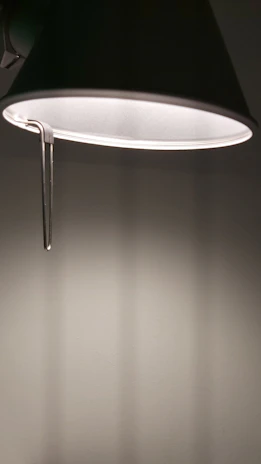Close-up of a sleek, modern lamp shaped like an open book casting soft light.
