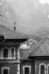 grayscale photography of house near mountain