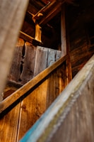 a close up of a wooden structure with a metal handrail