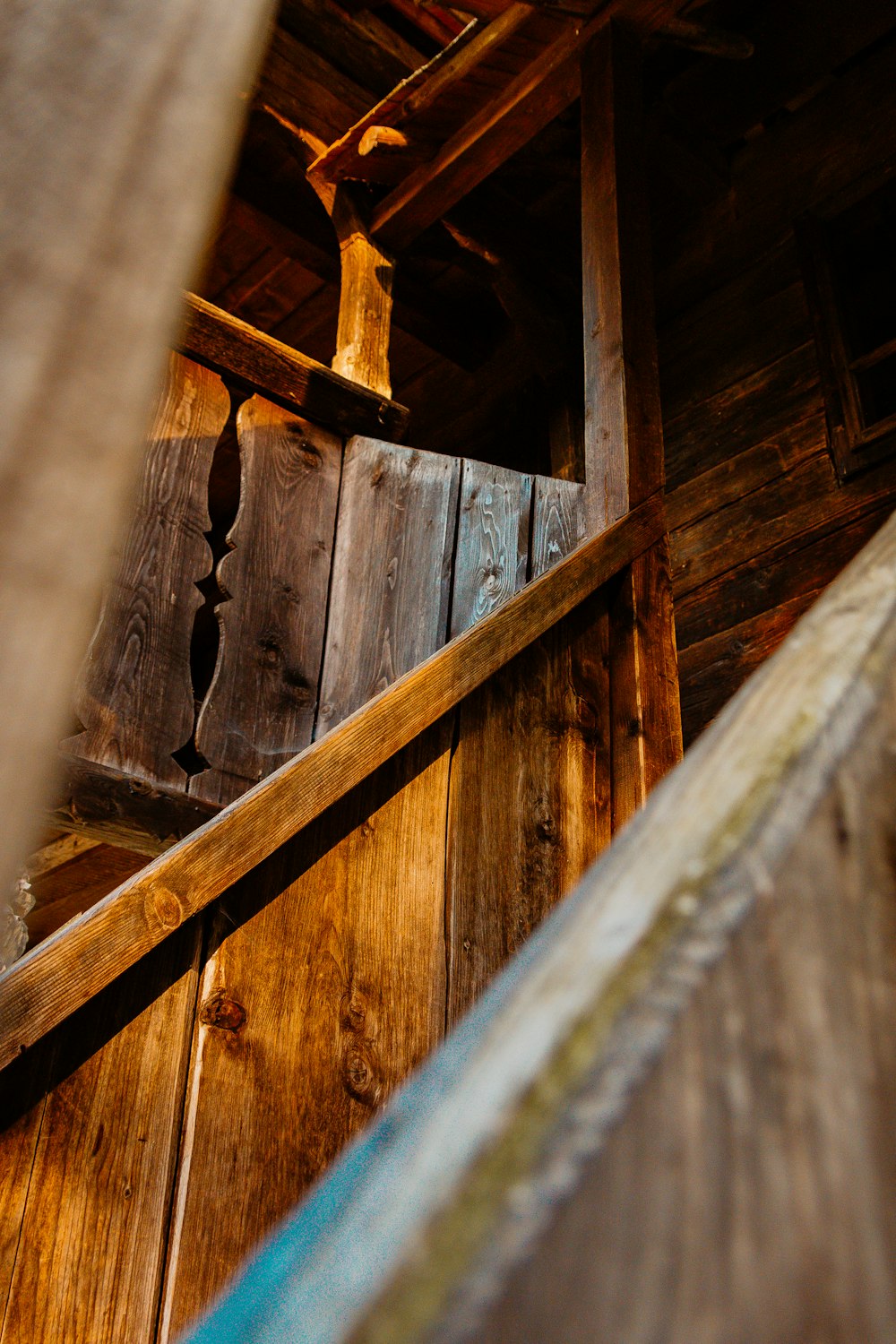 a close up of a wooden structure with a metal handrail