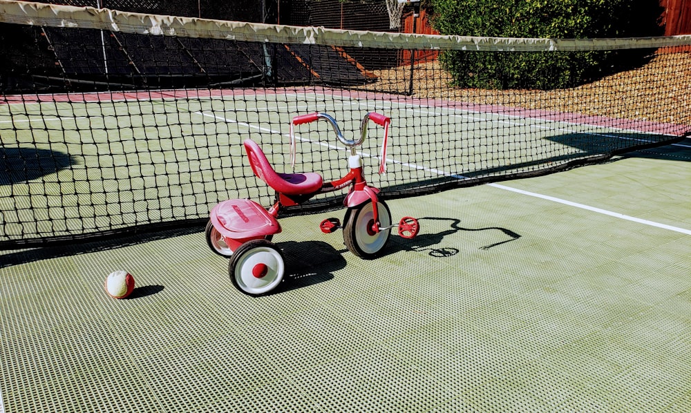 red and white Radio Flyer trike close-up photography