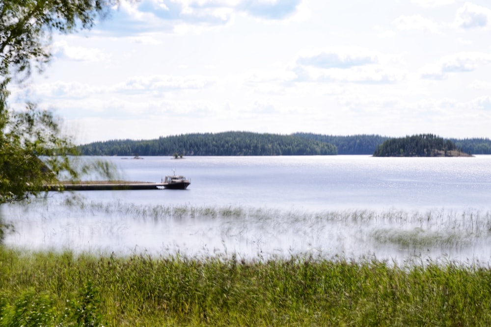 body of water near mountain at daytime