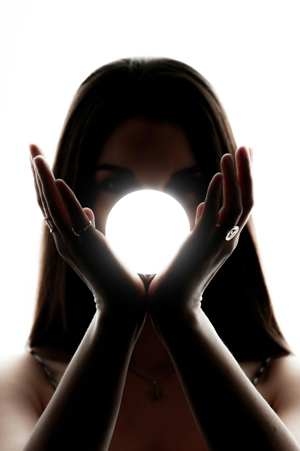 woman holding white ball light fixture