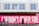 A group of people walk past a vivid pink sign with bold white text that reads 'LONDON'S OTHER SIDE'. In front of the sign, a row of bicycles is parked in a docking station. The background includes a building with a white facade and several windows.
