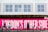 A group of people walk past a vivid pink sign with bold white text that reads 'LONDON'S OTHER SIDE'. In front of the sign, a row of bicycles is parked in a docking station. The background includes a building with a white facade and several windows.