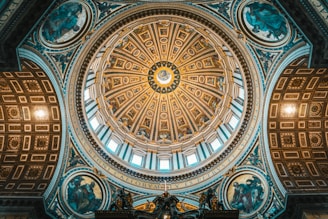 a domed ceiling in a building with statues on it