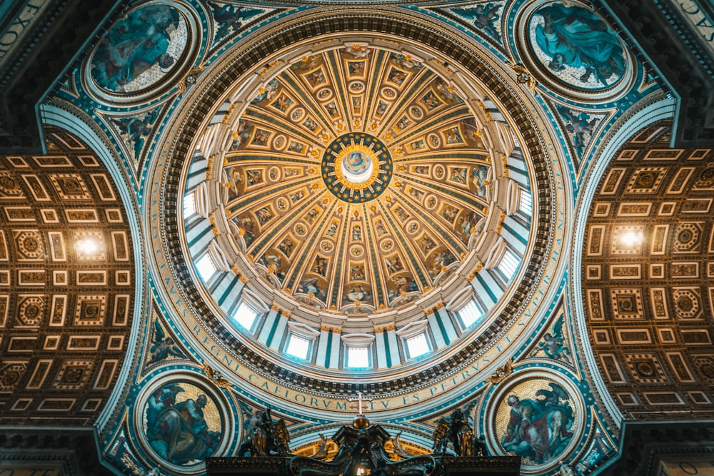 a domed ceiling in a building with statues on it