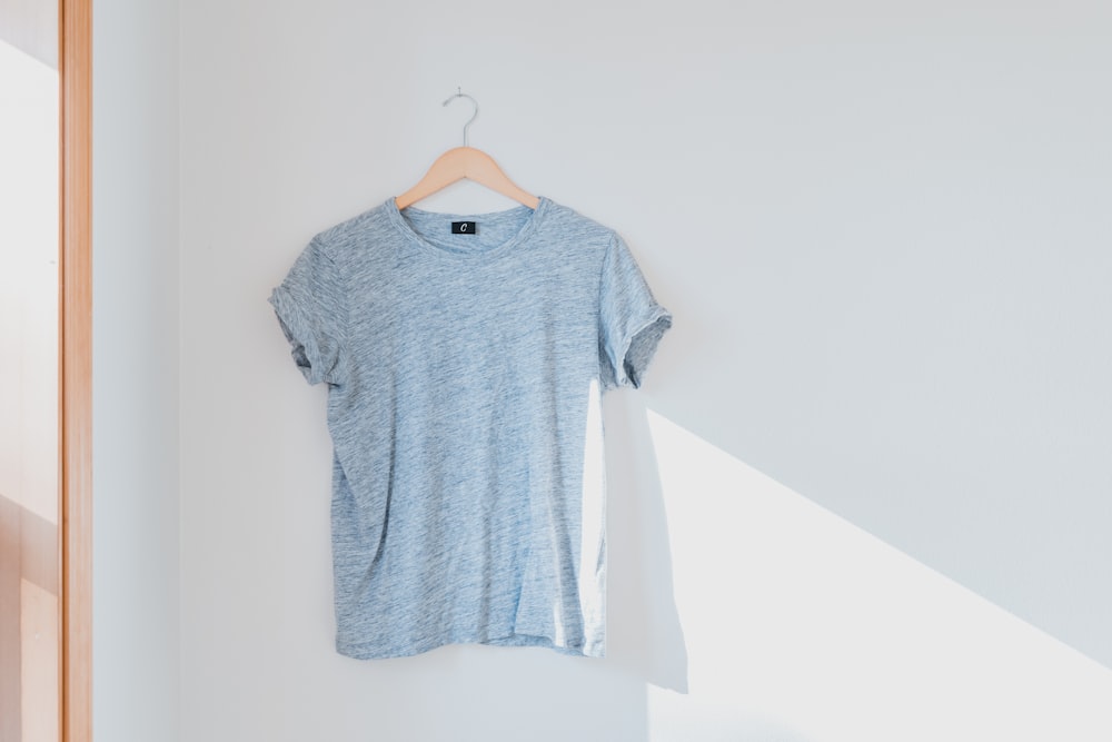 hanged grey shirt on white wall