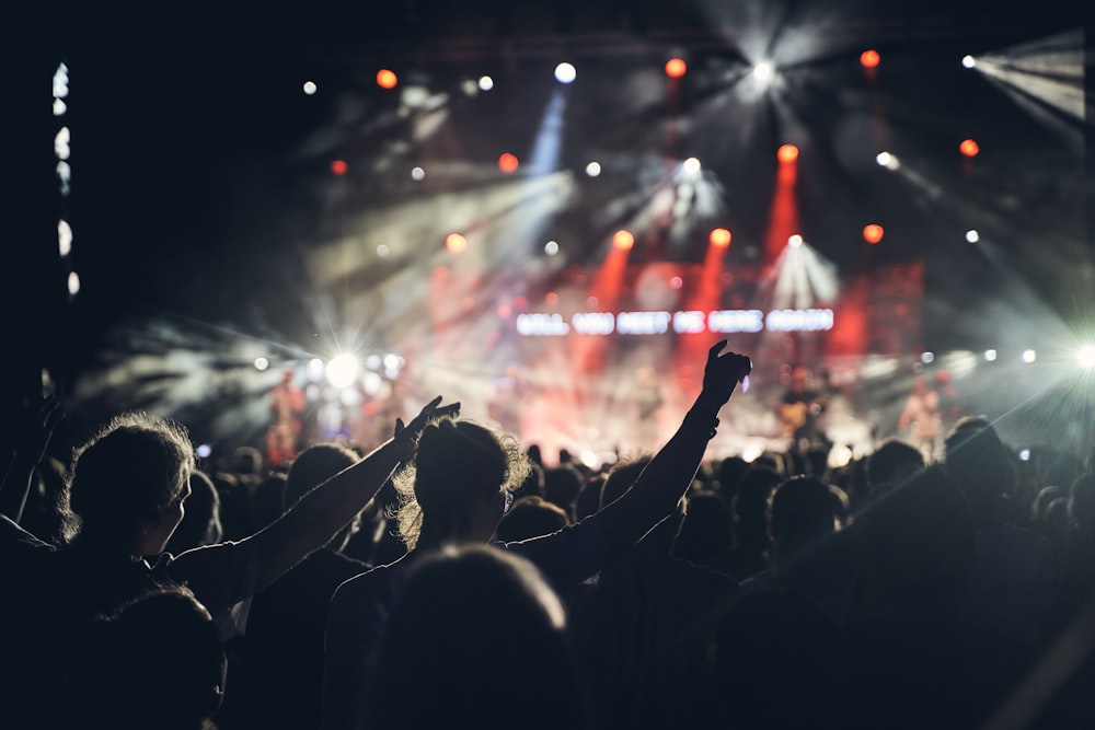 people watching group of people performing on stage