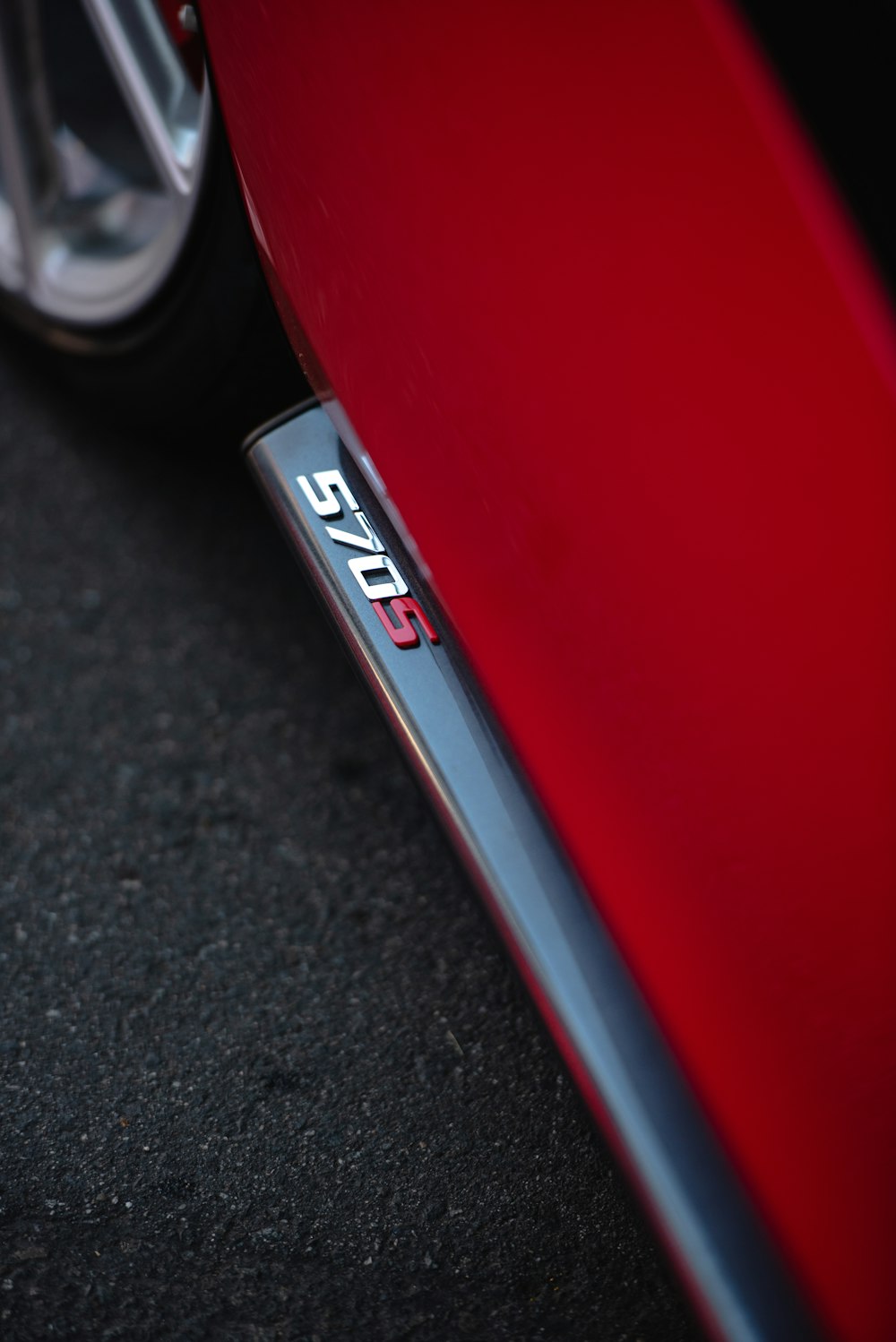 a close up of the emblem on a red car