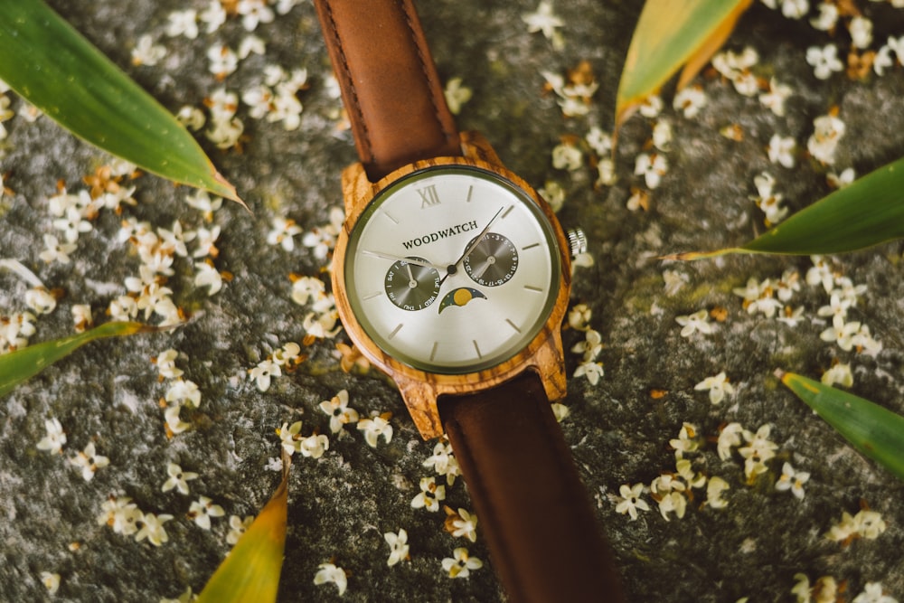 round brown framed analog watch
