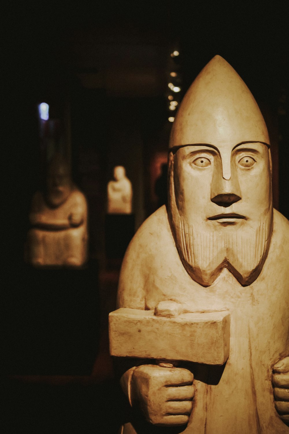 man holding hammer figurine