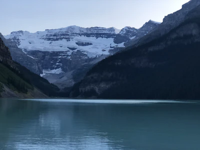 A peaceful lake reflecting the surrounding alpine scenery at Reschen Pass.