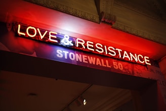love & resistance neon signage