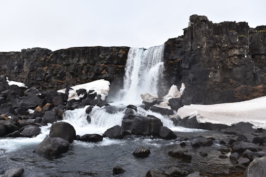 waterfalls under white clouds in Öxarárfoss Iceland