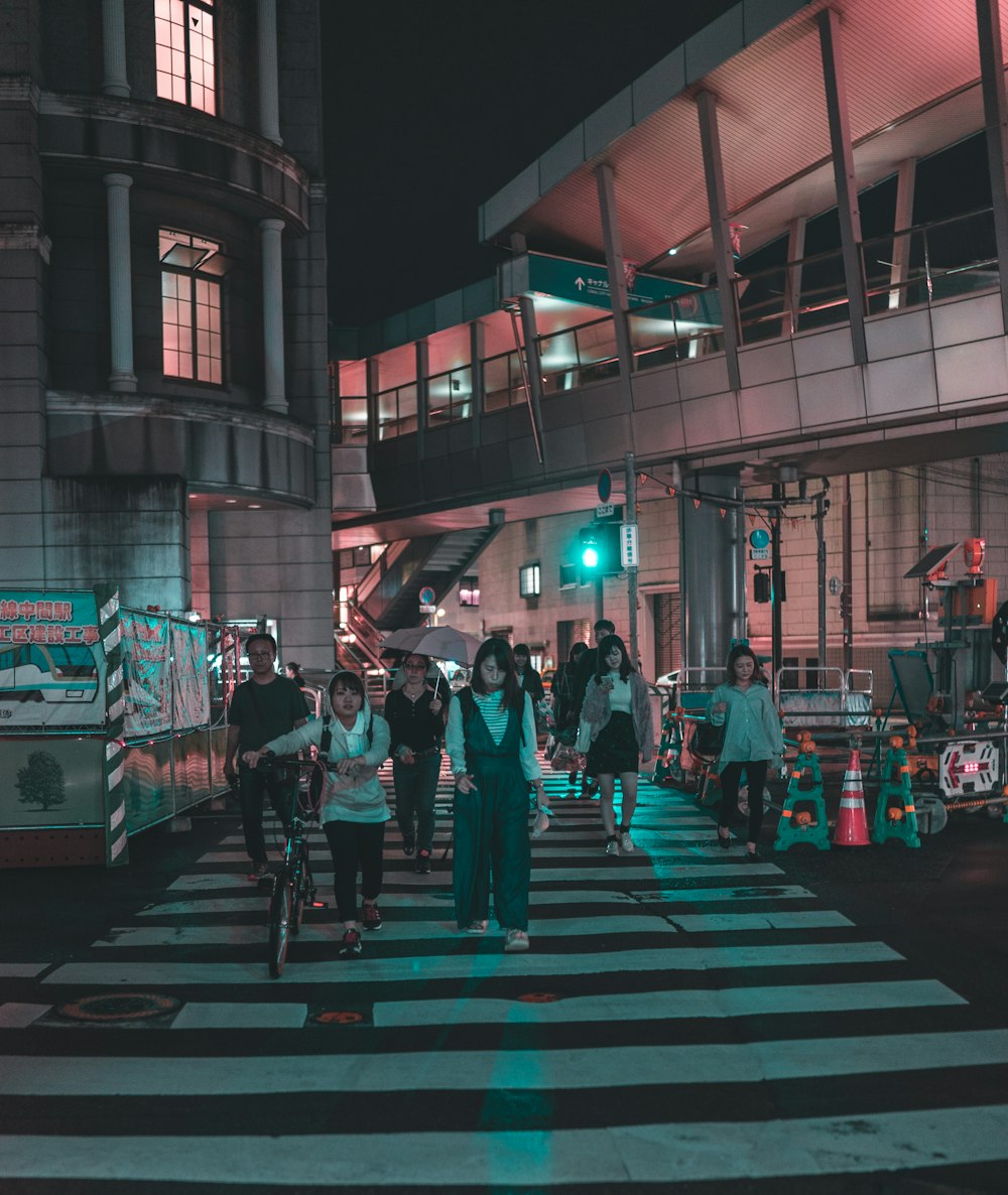 people crossing street during nighttime