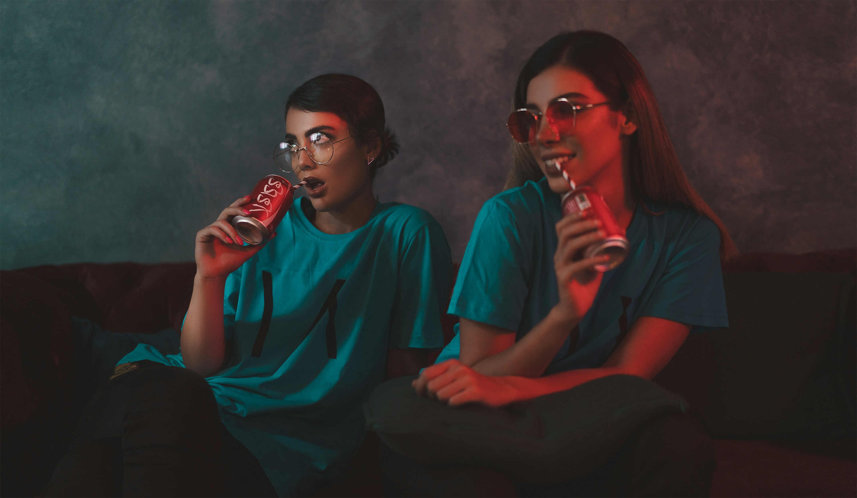 two woman wearing green crew-neck t-shirts