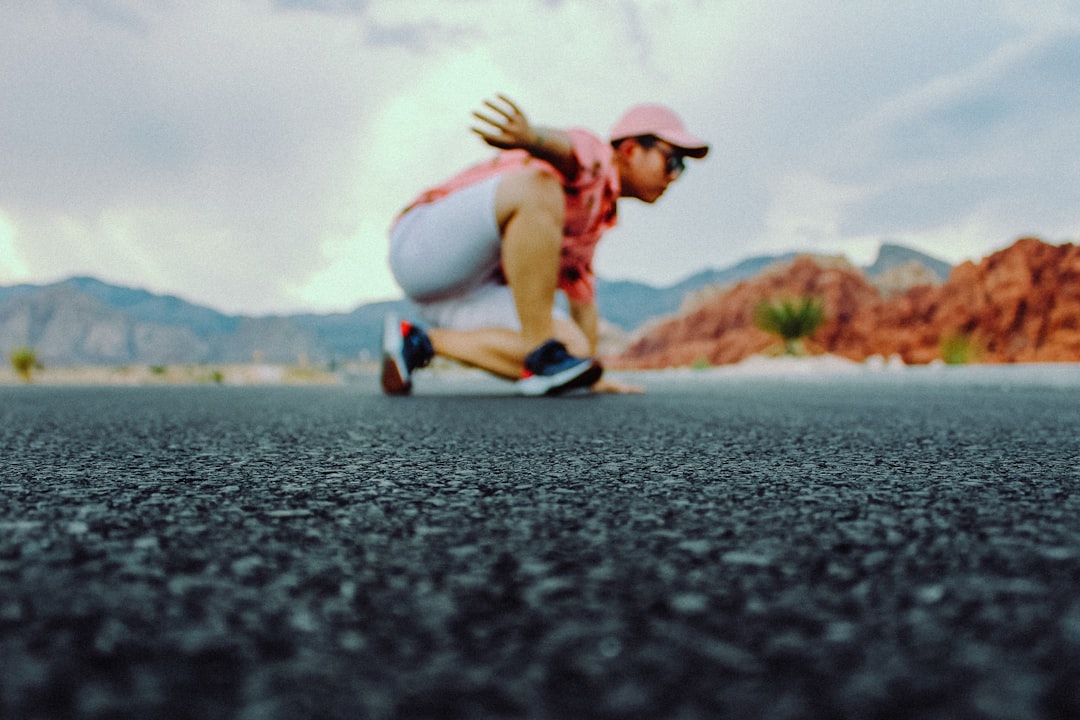 shallow focus photo of man wearing pink curved brim cap