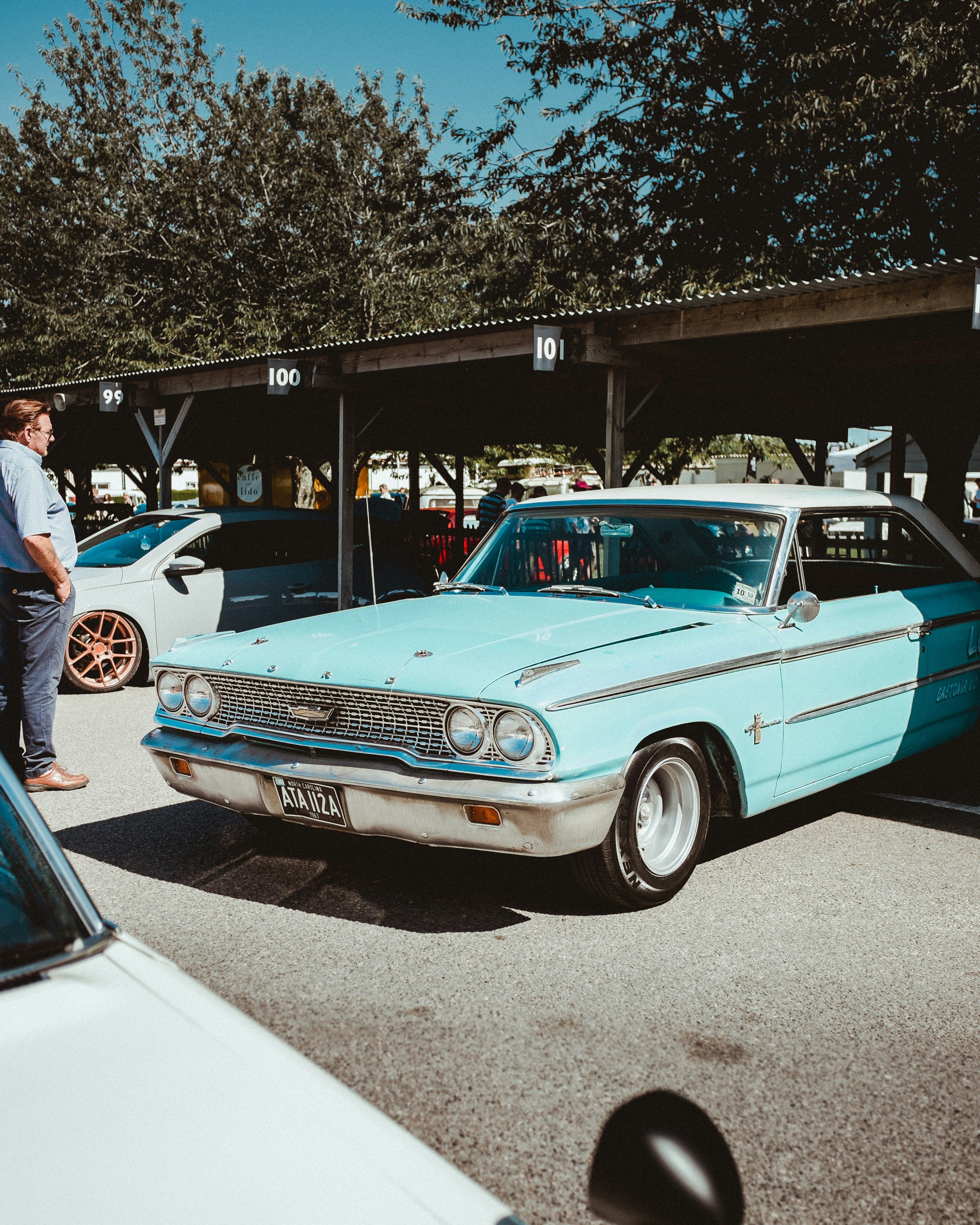 teal coupe parked on street
