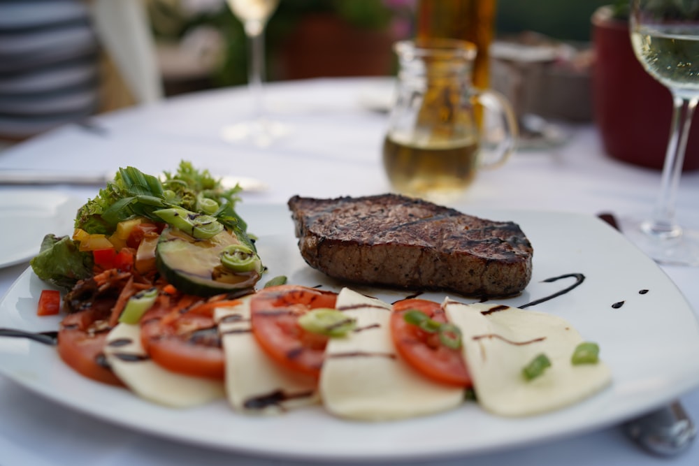 shallow focus photo of roasted meat on white ceramic plate