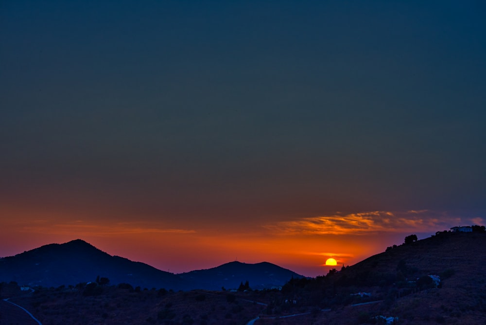 silhouette of mountains during nighttime