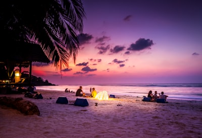 people sitting near seashore viewing sea under orange and blue skies vacation google meet background