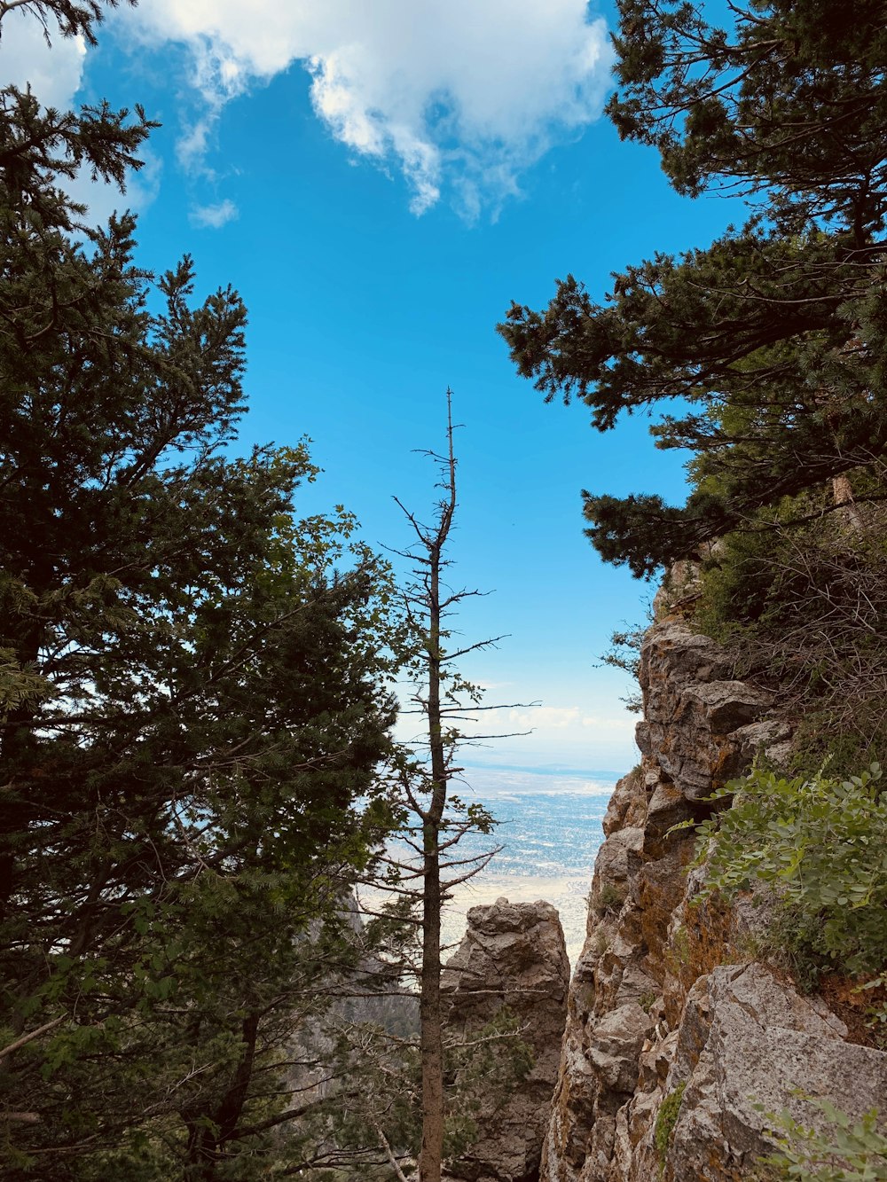 brown rock formation under blue sky and white clouds during daytime