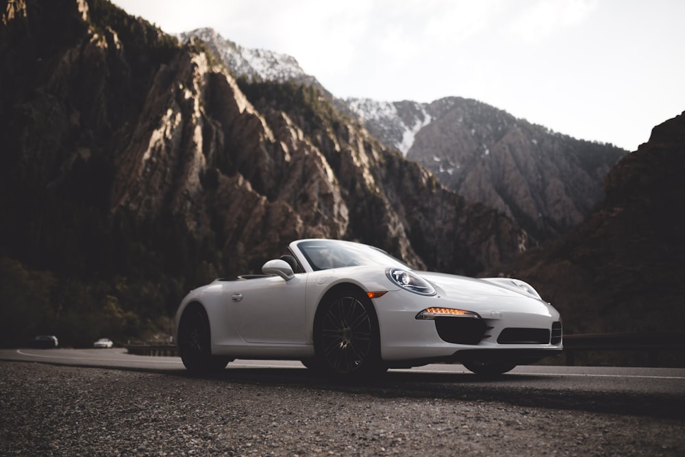 white Porsche convertible coupe on road