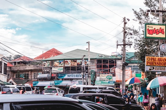 vehicles on road under white clouds in Baguio Philippines