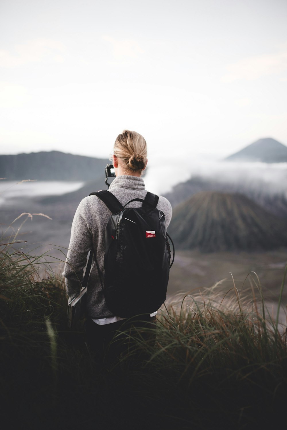 person carrying black backpack close-up photography