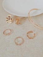 round floral floral earrings near empty white plate