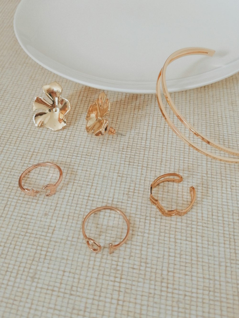 round floral floral earrings near empty white plate