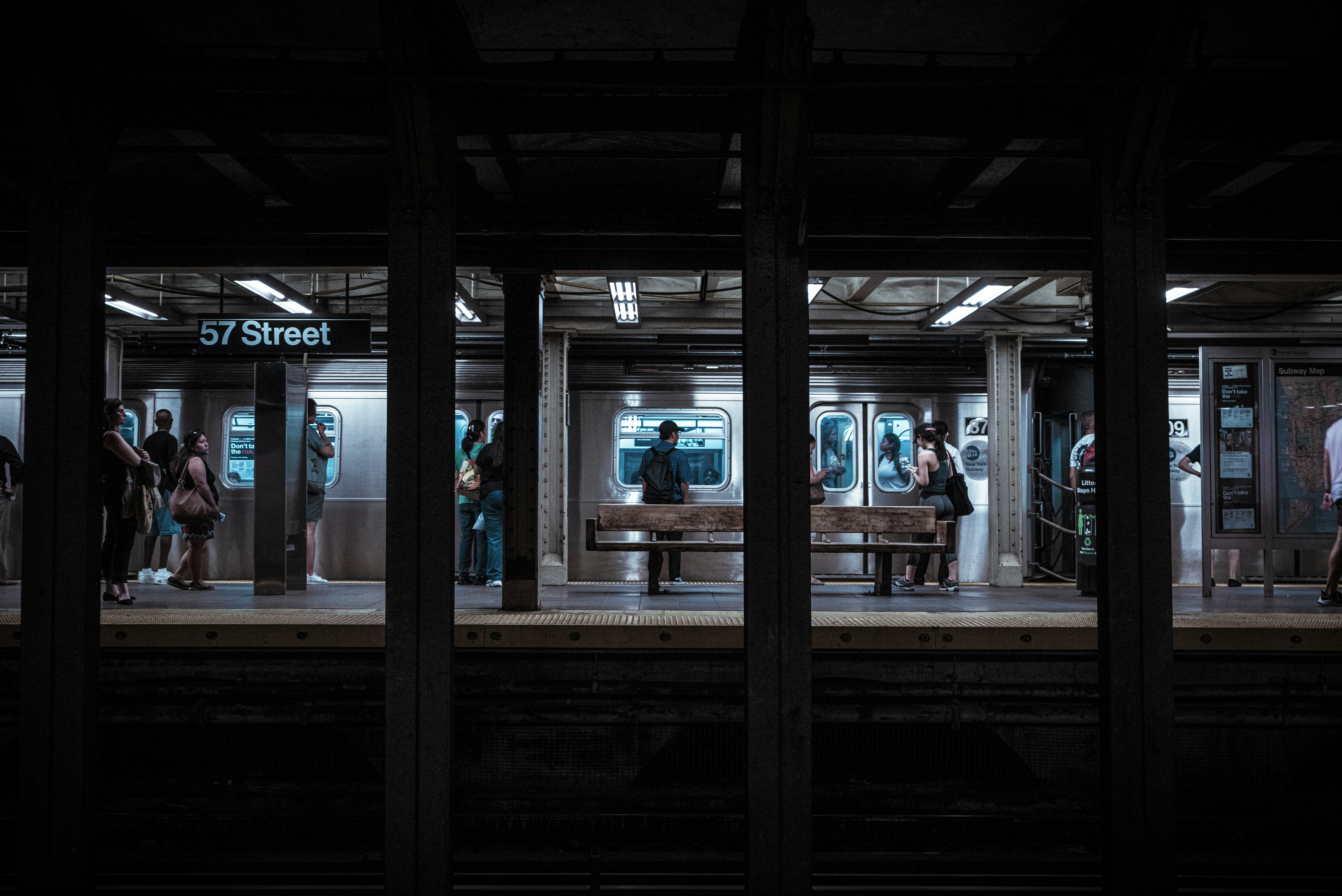 people standing under railway station