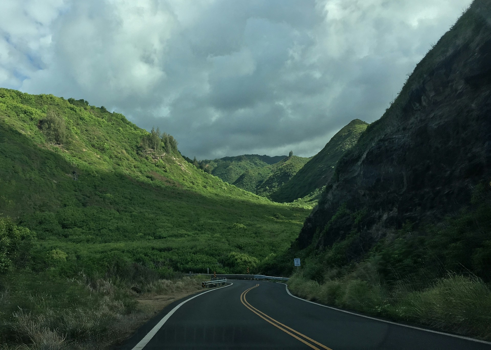 landscape photo of gray asphalt road towards mountains
