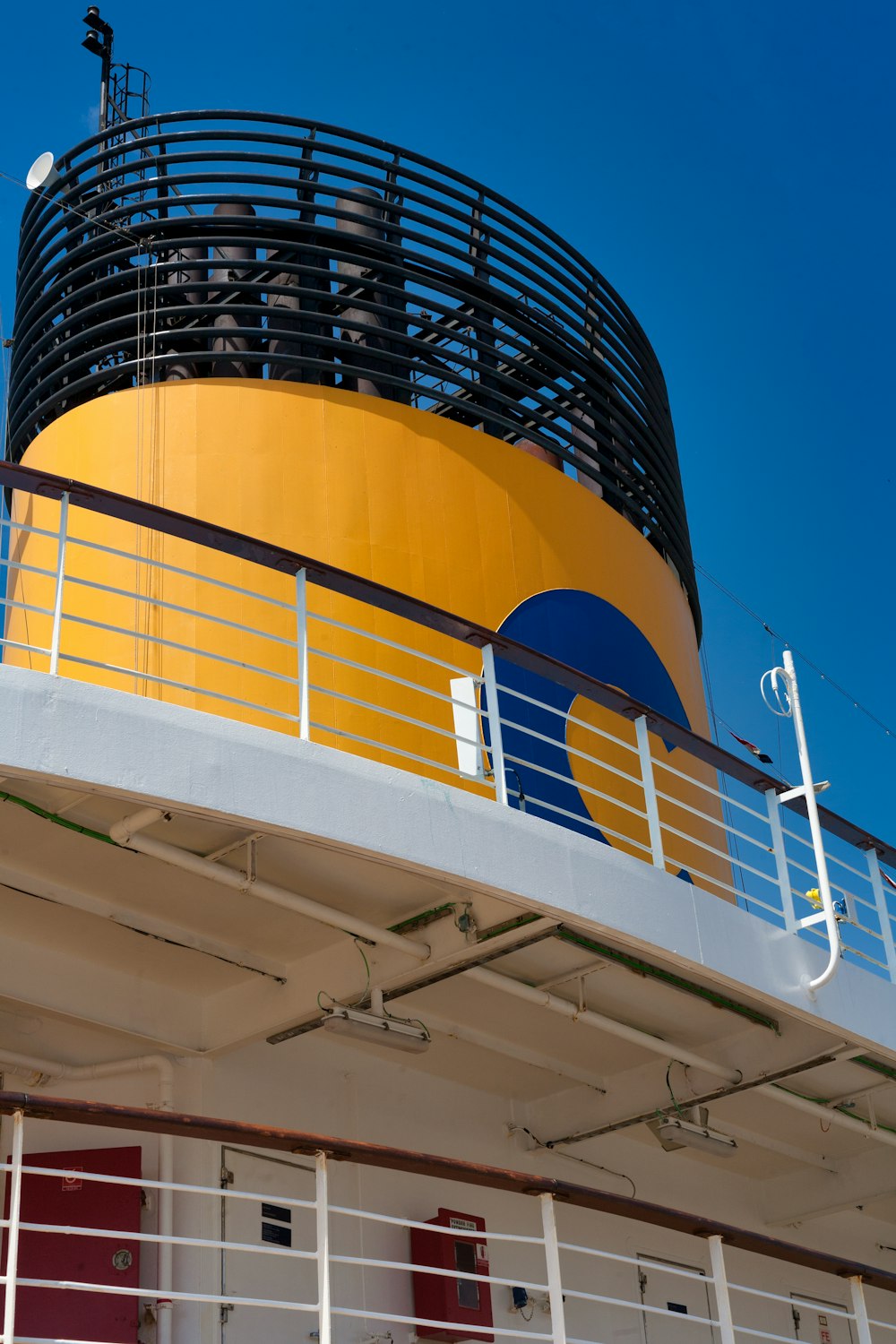 a large yellow and blue building with a clock on top