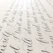 A close-up of elegant blush pink calligraphy on cream paper with navy blue accents.