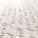 Elegant black cursive handwriting is beautifully arranged on a light-colored paper background, showcasing smooth curves and flowing script.